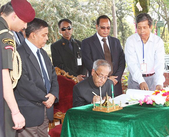 President Pranab writing a note in the visitor's book