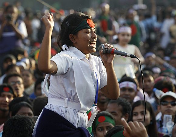 A student of the Holy Cross Girls' College shouts slogans as she attends a mass demonstration at Shahbagh intersection, demanding capital punishment for Bangladesh's Jamaat-e-Islami senior leader Abdul Quader Mollah, after a war crimes tribunal sentenced him to life imprisonment, in Dhaka