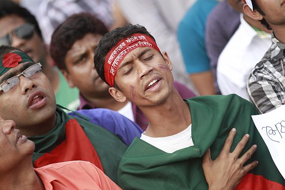 People sing Bangladesh's national anthem as they attend a mass demonstration at Shahbagh intersection
