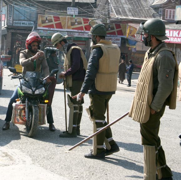 Security personnel seen stopping vehicles to seek details as curfew continued in parts of Srinagar on Wednesday
