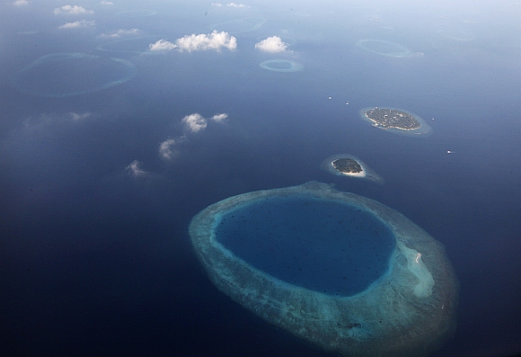 An aerial view shows an atoll in the Maldives. There are over 1,100 islands which are dispersed in the open sea, and sparsely populated