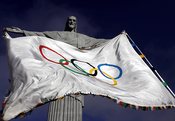 The Olympic Flag flies in front of 'Christ the Redeemer' statue during a blessing ceremony in Rio de Janeiro, where the next games will be hosted in 2016