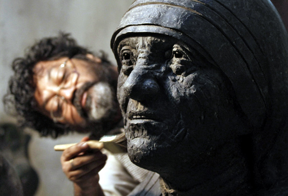 An artisan works on a statue of Mother Teresa in Kolkata