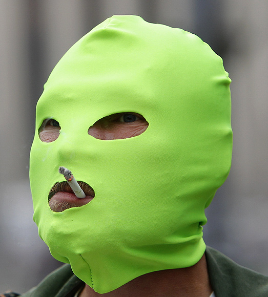 An protester wears a mask in support of members of a female punk band during a rally against Putin in Moscow