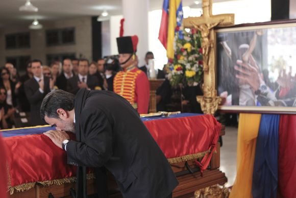 Iran's President Mahmoud Ahmadinejad pays tribute to Hugo Chavez, during the funeral service at the military academy in Caracas.