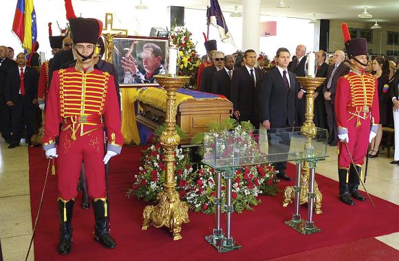 Visiting heads of state stand next to the coffin of Hugo Chavez during the funeral service in Caracas on Friday