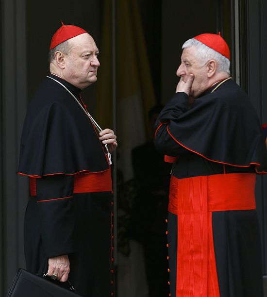 Italian Cardinal Gianfranco Ravasi (L) and Giuseppe Versaldi chat as they arrive for a meeting at the Synod Hall in the Vatican