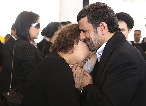 Iran's President Mahmoud Ahmadinejad offers his condolences to Elena Frias, mother of Venezuela's late President Hugo Chavez, during the funeral service at the Military Academy in Caracas