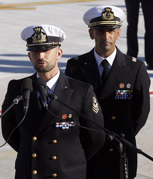 Italian marine Salvatore Girone (L) speaks to the media next to fellow marine Massimiliano Latorre after landing at Ciampino airport in Rome