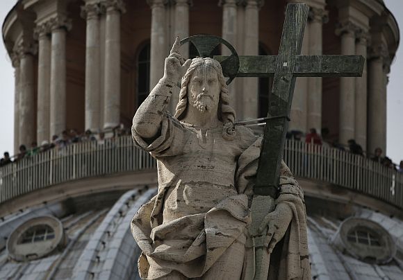 The statue of Jesus Christ at the dome of St Peter's Basilica at the Vatican.