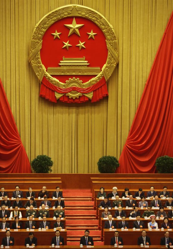 China's Politburo Standing Committee members, (1st row from L to R), Zhang Gaoli, Liu Yunshan, Zhang Dejiang, Xi Jinping, Li Keqiang, Yu Zhengsheng, Wang Qishan and other delegates attend the fifth plenary meeting of the National People's Congress in Beijing