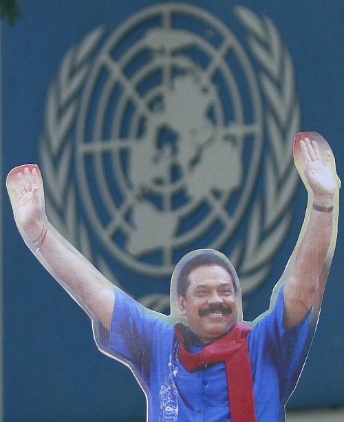 A demonstrator holds up an image of Sri Lanka's president Mahinda Rajapaksa in front of the United Nations (UN) head office during a protest in Colombo