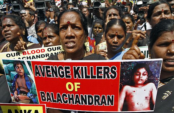 Demonstrators shout slogans as they hold placards during a protest against Sri Lanka's government in Chennai. Sri Lanka's government has faced heavy criticism after photographs obtained by Britain's Channel 4 suggested that 12-year-old Balachandran, son of Tamil Tiger leader Velupillai Prabhakaran, was murdered and not killed in crossfire during the chaotic end of the island's three-decade war. The government has denied killing Balachandran