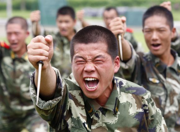 Paramilitary police train with plastic daggers at a military base in Suining, Sichuan province