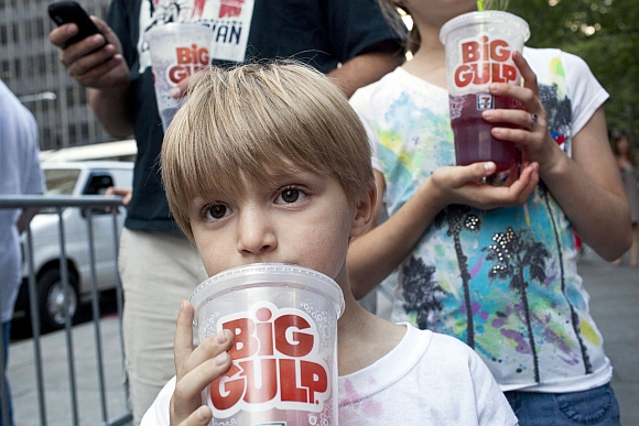 Benjamin Lesczynski, 8, of New York, takes a sip of a 'Big Gulp' while protesting the proposed 'soda-ban', that New York City Mayor Michael R Bloomberg has suggested, outside City Hall in New York