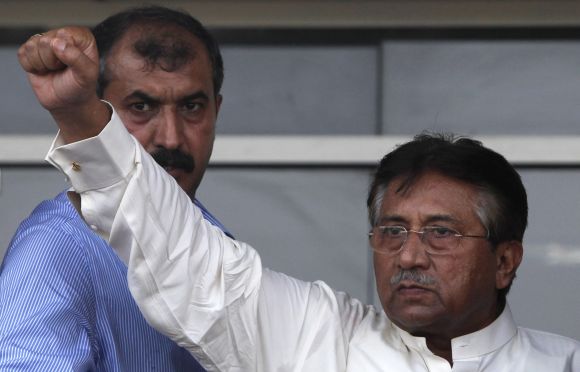 Pervez Musharraf gestures to his supporters upon his arrival from Dubai at Jinnah International airport in Karachi on Sunday