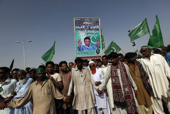 Supporters of Musharraf wait upon his arrival from Dubai at the Karachi airport