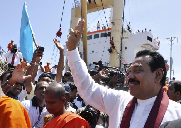 Sri Lanka's President Mahinda Rajapaksa waves at the crowd after the first ship docked at the port in Hambantota.