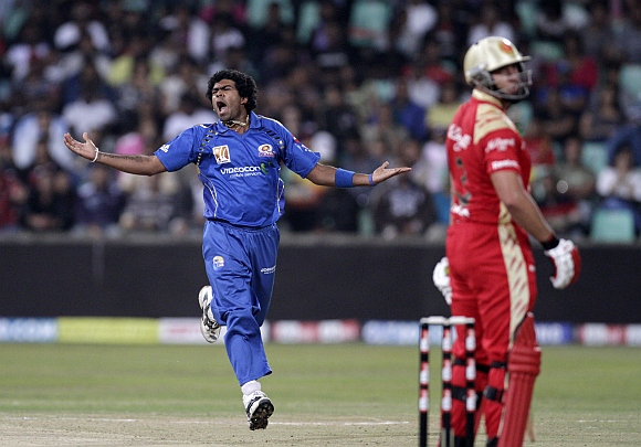 Mumbai Indians' Lasith Malinga, (left) reacts after nearly claiming the wicket of Royal Challengers Bangalore's Jacques Kallis during their Twenty20 cricket match at Kingsmead Stadium in Durban