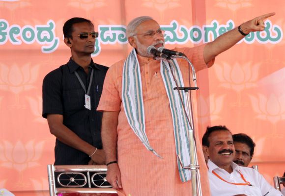 Narendra Modi gestures while addressing supporters at a campaign rally in Mangalore on Thursday