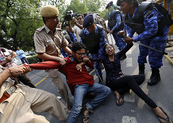 Police try to stop protestors during a demonstration against sexual violence in Delhi
