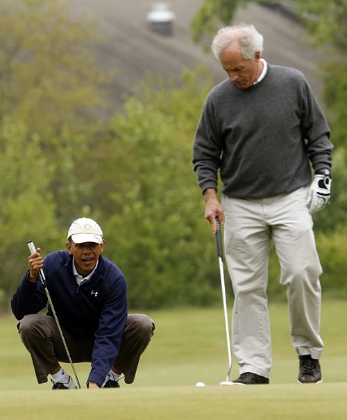 US President Barack Obama lines up his putt as Senator Bob Corker looks on during a round of golf at Joint Base Andrews in Maryland. Senators Saxby Chambliss (R-GA) and Mark Udall (D-COL) also played in the foursome