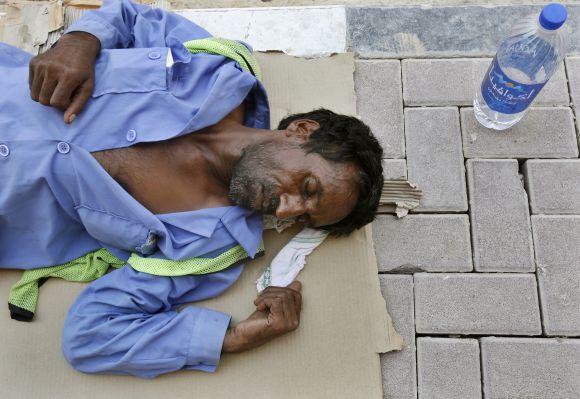 A migrant worker at a construction site on a hot summer day in Dubai.