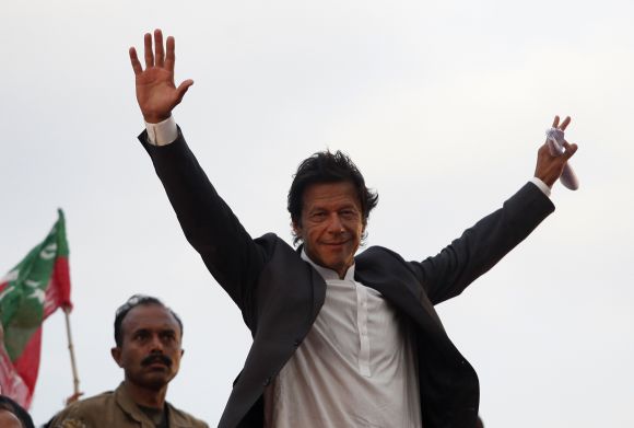Imran Khan, Pakistani cricketer-turned-politician, Chairman of political party Pakistan Tehreek-e- Insaf (PTI) waves to his supporters during a rally in Lahore