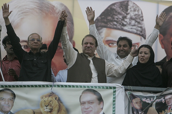 Nawaz Sharif cheers his supporters during an election campaign rally in Mandi Bahauddin, Punjab province