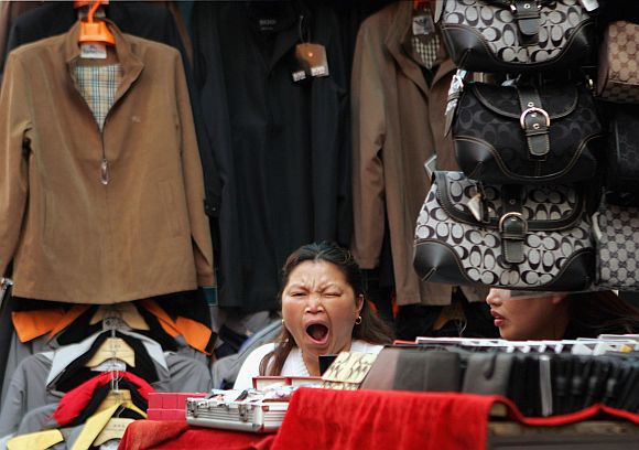 A vendors sells Chinese-made clothes at a garment market