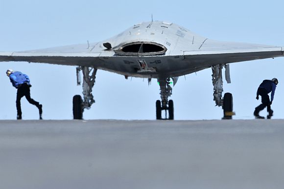 Sailors assigned to the aircraft carrier USS George H W Bush prepare to launch an X-47B Unmanned Combat Air System