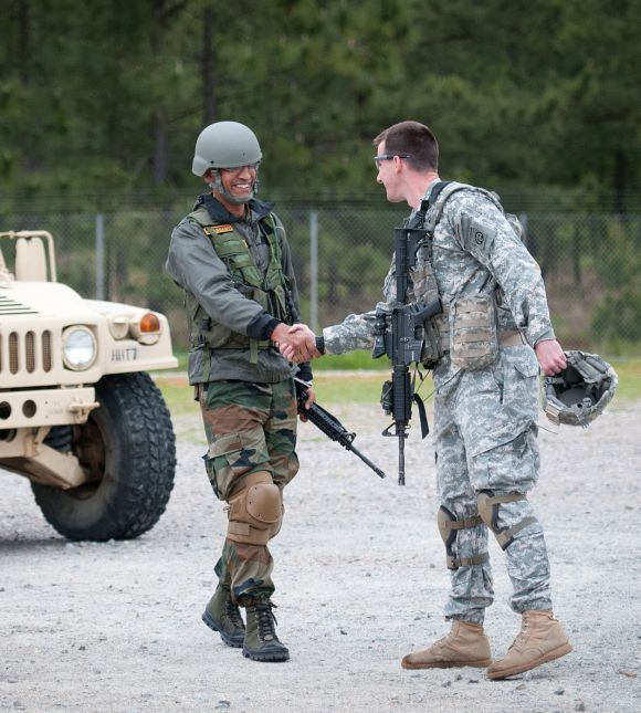 Indian Army Major Prashant Mishra, a company commander with 2nd Battalion, 5th Gurkha Rifles, 99th Mountain Brigade, is welcomed to a weapons range by Capt Cullen Lind, a company commander with the 82nd Airborne Division's 1st Brigade Combat Team