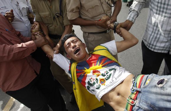 A Tibetan exile is detained by police outside the Chinese embassy during a protest against the visit of Li Keqiang, in New Delhi, on Sunday