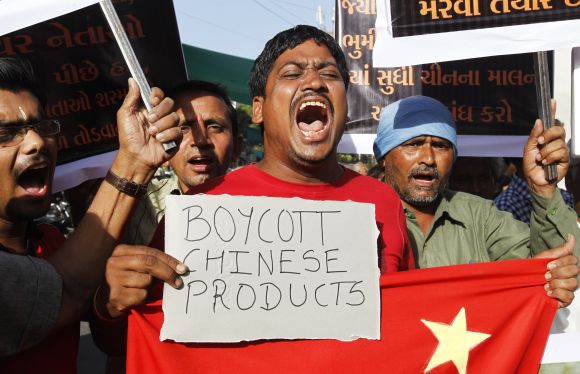 Traders shout slogans during a protest against China in Ahmedabad