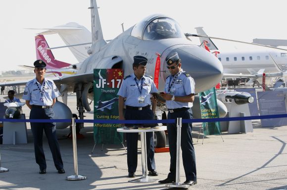 Pakistani pilots stand in front of the JF-17 Thunder fighter plane during the Dubai Airshow
