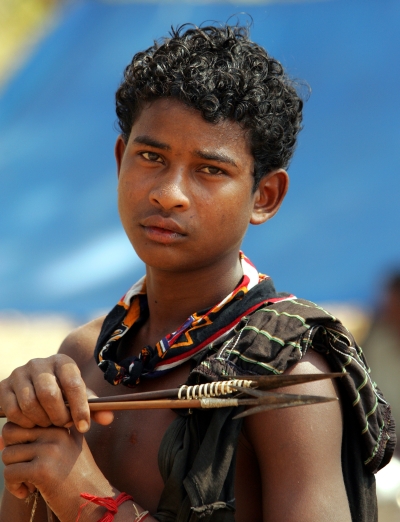 An tribal teenager holds a bow and arrows in Dharbaguda, in the central state of Chhattisgarh