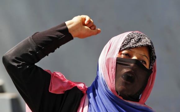 A veiled Kashmiri Muslim woman shouts slogans during a protest rally in Srinagar