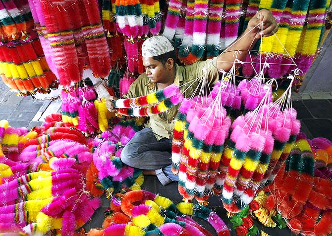 A vendor arranges garlands for sale in his shop before the festival of lights, Diwali in Ahmedabad, Gujarat.