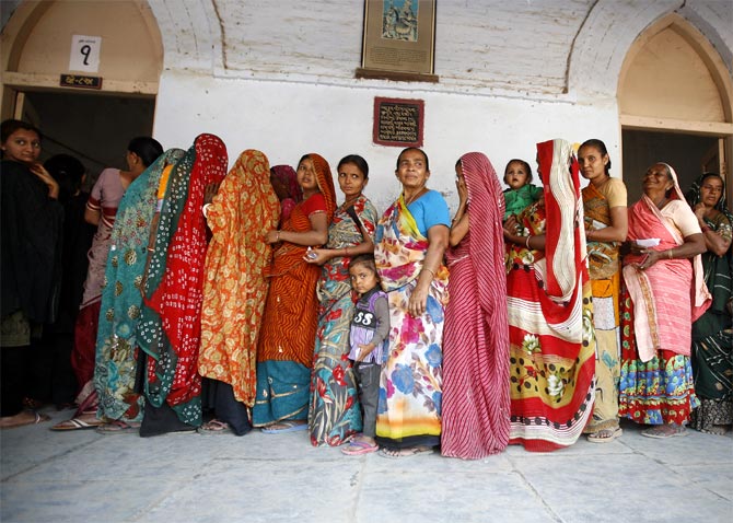 Women wait to cast their ballots outside a polling booth in Viramgam, Gujarat, December 2012.