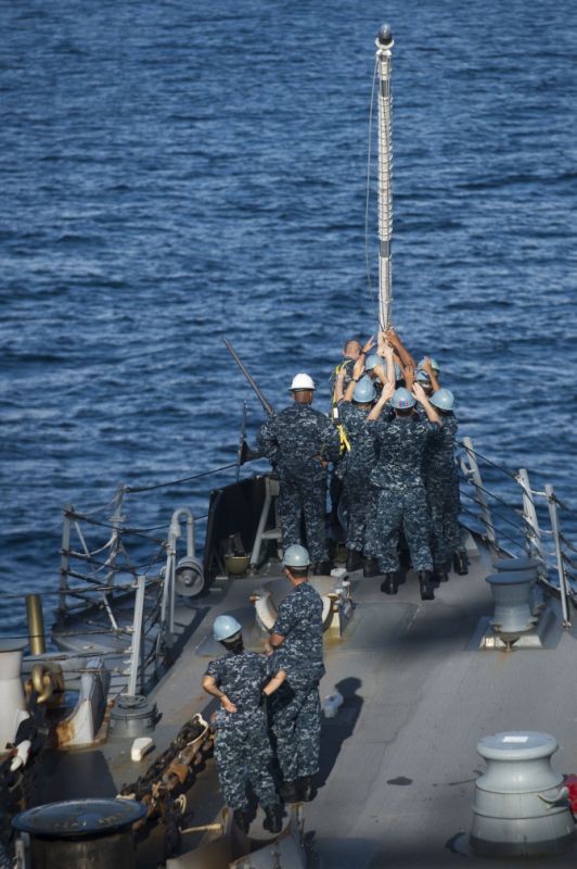 Sailors aboard the Arleigh Burke-class guided-missile destroyer USS McCampbell (DDG 85) work together to raise the jack-staff as the ship arrives in Chennai for a port visit.