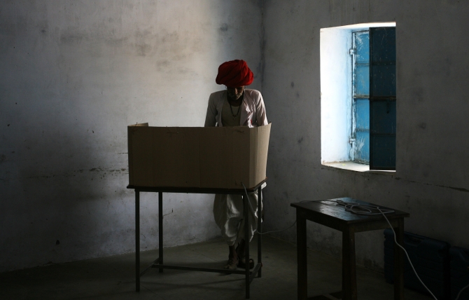 A man casts his vote at a polling centre in Rajasthan