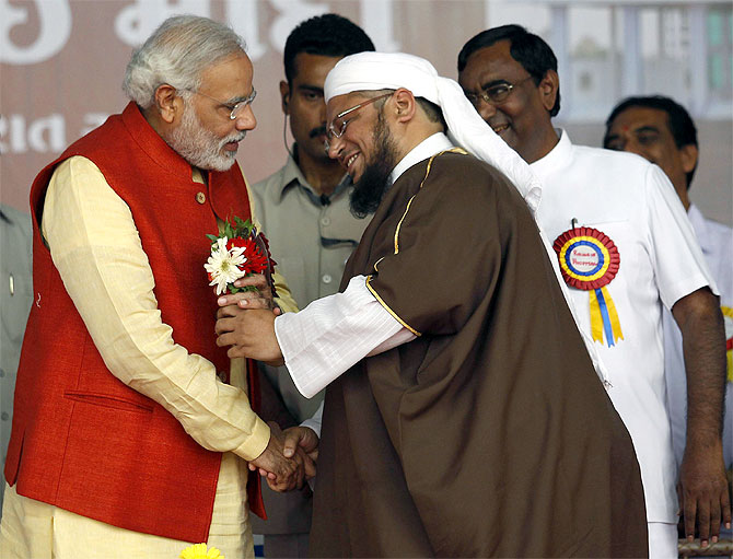 BJP prime ministerial candidate Narendra Modi receives flowers from a Muslim cleric after the inauguration of a hospital run by a Muslim trust in Balasinore, near Ahmedabad.