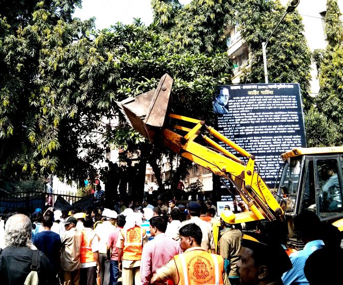 A Brihanmumbai Municipal Corporation bulldozer waits outside the Campa Cola housing society.
