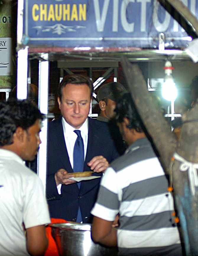 British Prime Minister David Cameron having 'dal bora' from a roadside shop during his Kolkata visit