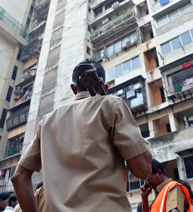 A municipal worker at the Campa Cola building compound in Worli, south-central Mumbai, November 13, 2013.