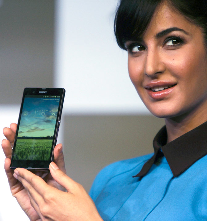 Katrina Kaif displays a smartphone during its launch