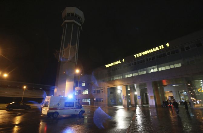An ambulance is seen outside the main building of Kazan airport following the plane crash on Sunday
