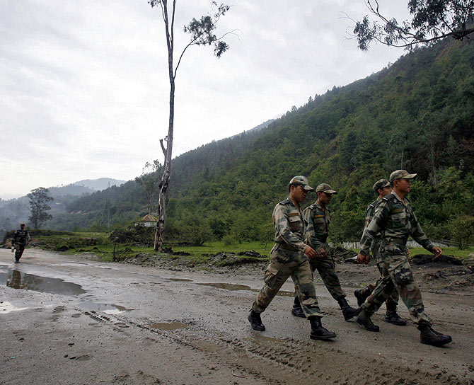 Indian soldiers march near an army base on India's Tezpur-Tawang highway, which runs to the Chinese border, in Arunachal Pradesh