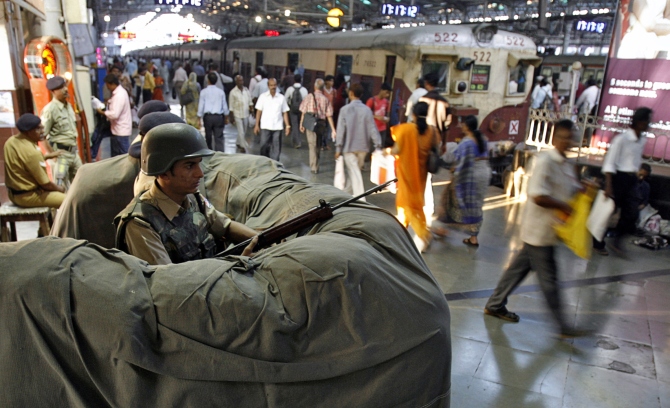 A railway police commando stands guard at the Chhatrapati Shivaji Terminus, one of the sites of the 26/11 attacks in Mumbai.