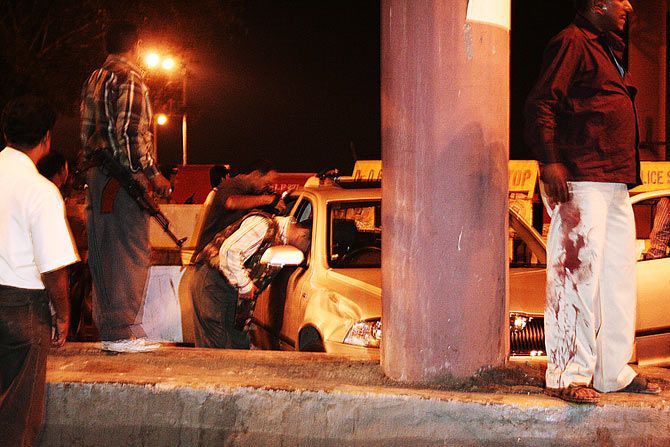 November 26, 2008, after midnight: After terrorist Ajmal Kasab's capture, a team of policemen check the Skoda Laura that he and his accomplice commandeered at Nariman Point and drove down Marine Drive. Photograph: Uttam Ghosh/Rediff.com